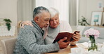 Bible, love and a senior couple reading a book in their home together for religion, faith or belief. God, Jesus or Christ with a spiritual man and woman in worship or prayer during retirement 