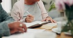 Hands, writing and bible in home with woman, man and retirement with study, faith and notes for religion. Senior people, notebook and analysis of holy scripture, spiritual growth and gospel in house