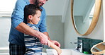 Washing hands, bathroom and a father and child at home teaching and learning about good hygiene. A happy man and a kid together in family house for health, wellness and help with cleaning in morning