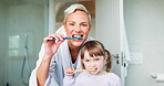 Face, mom and girl kid brushing teeth in home for hygiene, morning routine and learning healthy oral habits. Portrait of woman, child and dental cleaning with toothbrush for self care of fresh breath