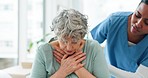 Nurse with a senior woman with chest pain in the hospital during a medical consultation. Healthcare, checkup and elderly female patient coughing with heart problem with a doctor in a medicare clinic.