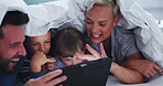 Parents, children and tablet with blanket in bedroom for games, online learning and reading ebook media. Family of mom, dad and kids relax with digital technology, watching cartoon and story at night