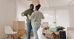 Black couple, moving in and celebrate at home with boxes in a room. New house, goals and excited african man and woman with commitment, help and support for apartment mortgage or rent at a property