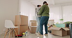 Moving in, happy couple and celebrate at home with boxes in a room. New house, romance and love of black man and woman at a property with commitment, help and support for apartment mortgage or rent