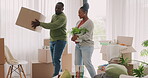 Moving in, happy couple and boxes at home for real estate and fresh start. New house, plant and love of black man and woman at property with commitment, help or support for apartment mortgage or rent