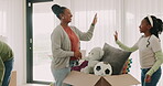 New home, black family and high five, play in box and happy in living room of property. Real estate, African mother and children with father celebrate success, moving or smile in house for relocation