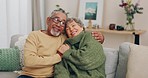 Holding hands, hug and senior couple at home in marriage and retirement with love, support and care. House, living room and elderly people relax on a sofa with embrace and happy with smile together