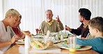 Family, lunch and conversation in dining room with love, bonding and communication at home. Food, relax and children with grandparents, parents and healthy, meal and nutrition while enjoying weekend