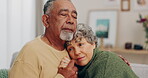 Love, hug and senior couple with empathy and comfort or security on home sofa. Elderly man and sad woman embrace and together in living room for care, compassion and support or sympathy in retirement