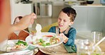 Lunch, dining room and mother dish her child healthy food for health, wellness and nutrition. Happy, hungry and young boy kid with a plate for a meal or supper at his modern home for a family dinner.