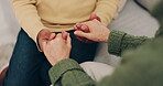 Couple, love and holding hands for empathy and support or security on home sofa. Closeup of man and woman together in living room for trust, compassion and help or kindness with care in retirement