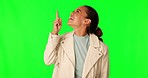 Green screen, pointing up and happy woman excited for mockup advertising space, sales promotion or news announcement. Brand notification, chroma key and person gesture at choice on studio background