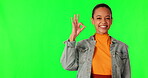 Happy woman, OK hand gesture and green screen, emoji and agreement with vote, mockup space and review. Feedback, voice and opinion, female person in portrait and yes, like sign on studio background
