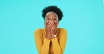 Laughing, face and a funny black woman on a blue background for a meme, reaction or comedy. Happy, comic and portrait of a young African girl or person with crazy expression isolated on a backdrop