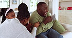 Family, laughing and playing on a home sofa with a mother, father and child bonding with love. African man, woman and kid relax on a couch for funny game and happiness on fathers day at a house