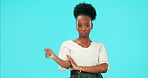 Attitude, face and a black woman with a gesture on a blue background with sassy expression or behavior. Serious, brat and portrait of an African girl with a hand sign isolated on a studio backdrop