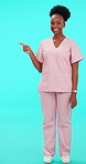 Smile, pointing and checklist with a nurse black woman on blue background in studio for healthcare. Portrait, medical and confident with a young female medicine professional in scrubs for information