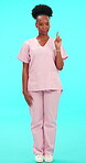 Smile, palm and advice with a nurse black woman on blue background in studio for healthcare. Portrait, medical and feedback with a young female medicine professional in scrubs to review a product