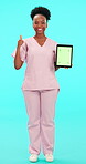 Tablet, green screen and thumbs up with a nurse black woman on blue background in studio for healthcare. Portrait, medical and chromakey with tracking markers in the hand of a medicine professional