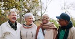 Nature, laughing and elderly friends walking in an outdoor park for fresh air and exercise. Happy, smile and group of senior people talking for bonding, having fun and exploring a garden together.