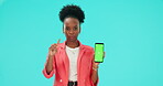 No, phone and black woman pointing to green screen in studio isolated on a blue background. Mobile, mockup space and bad review for promotion, marketing or advertising tracking markers in portrait