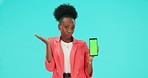 Confused face, phone and black woman with green screen in studio isolated on a blue background. Mobile, mockup space and person with doubt shrug, question and advertising tracking markers in portrait