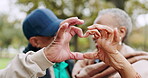 Senior, love and couple heart hands for trust, support and care together in outdoor forest, park or nature. Morning, man and elderly woman on retirement holiday or vacation in the woods for romance