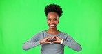 Black woman with smile on face, heart hands and green screen with care, kindness or gesture. Thank you, like and happy girl with love hand sign, emoji or icon on isolated on color background portrait