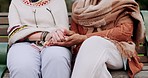 Senior friends, park and holding hands with support, comfort and hope outdoor. Bench garden sitting and mature people with retirement, empathy and kindness gesture for friendship and trust together