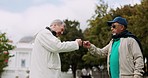 Handshake, hug and fist bump with elderly friends with bonding in retirement outdoor. Urban, vacation and excited senior men together on holiday in New York with smile and joy from travel and freedom