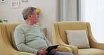 Home, thinking and old man with tablet, connection and retirement with memory, app and social media. Pensioner on a couch, relax and senior person with technology, wellness or ideas with nostalgia