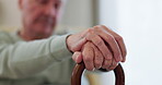 Elderly man, hands and walking stick or wood cane on sofa for balance, support or mobility in retirement or nursing home. Senior patient, closeup and old person with a disability or arthritis aid