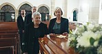 Senior women, coffin and funeral in church for memory, support and condolences with religion with family. Community, friends and together for death, loss and service with empathy, faith and casket