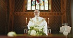 Funeral, church and priest praying by coffin for memorial service, sermon and ceremony for death. Religion, guidance and male pastor for prayer with congregation for comfort with casket in chapel