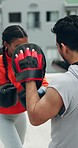 Boxing, woman closeup and rooftop with personal trainer, fitness and workout with cardio. Exercise, sport and kickboxing for fight outdoor with a man coach and female athlete for strength training