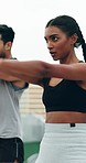 Exercise, woman closeup and rooftop with kettle bell, health and workout in city. Personal trainer, strength training and motivation of a woman and man on a roof with sports and weight for fitness