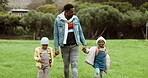 Father, love and children holding hands in park with parent in nature, outdoors in countryside together. Black family, siblings and dad walking, bonding or enjoying holiday vacation with kids or care