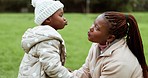 Playful, love and mother and child in park with silly, goofy and funny faces for bonding. Nature, happy and African young mom playing with her girl baby kid in an outdoor garden for family adventure.