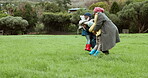 Grandparents, love or happy kids hug in park with parent in countryside nature together for support. Black family, grandfather or children running or bonding with grandmother on holiday vacation 