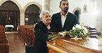 Flowers on coffin, senior mother and man mourning death in church for funeral. Floral casket, family and son with mom with bouquet for burial, grief or interracial for depressed or sad elderly woman