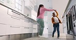 Happy mother, kitchen and black family child dance, smile and enjoy fun time together, music and excited energy. Spin, happiness and home mom, mama and African woman teaching, twirl and support kid