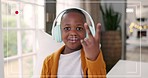 Live streaming, wave and face of a child on a video call with a peace sign for education in a house. Happy, hello and portrait of an African child with headphones and recording on a school webinar