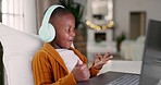 Headphones, elearning and child doing math counting for assignment, project or homework. Education, technology and young African kid student working on a computer for homework at his modern house.