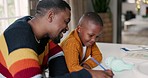 Black family, writing and father with child for education, learning and creative lesson at home. School, academic and happy dad teaching boy at table write for development, homework and studying