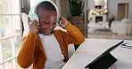 Headphones, music and child dancing with a tablet while watching a video on social media or the internet. Digital technology, moving and African boy kid listening to a song, playlist or album at home