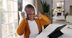 Headphones, tablet and boy child dancing to music, playlist or album online in the dining room. Digital technology, young and African kid moving while listening to a song or radio at modern home.