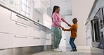 Happy mother, kitchen and black family kid dance, helping and enjoy fun time together, listening to music and excited energy. Mom holding hands, smile and African woman teaching young child at home