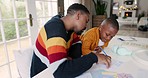 Learning, writing and father with kid for education, knowledge and creative activity at home. School, happy family and dad teaching boy at table write for child development, homework and studying