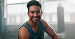 Fitness, face and young man in the gym after a strength training workout for health or muscles. Happy, sports and portrait of a strong male athlete body builder after an arm exercise in sport center.