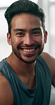 Sports, face and male athlete in the gym after a strength training workout for health or muscles. Happy, fitness and portrait of a young strong man body builder after an arm exercise in sport center.